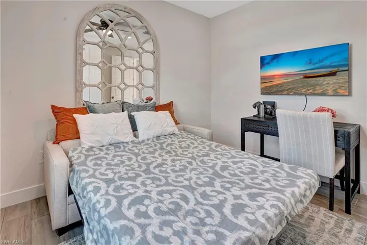Bedroom with light wood-style flooring and baseboards