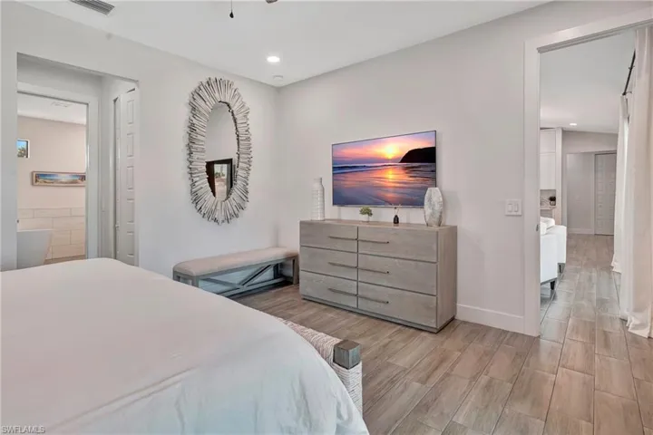 Bedroom with wood finish floors and recessed lighting