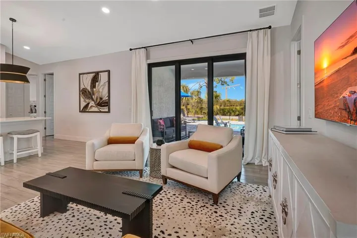 Living area featuring light wood-style flooring and recessed lighting