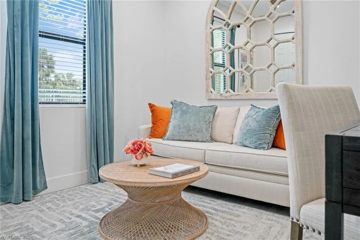 Sitting room featuring plenty of natural light and carpet flooring