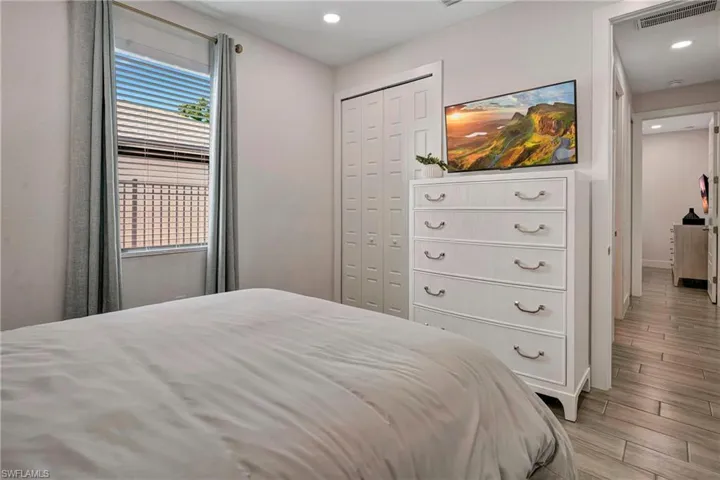 Bedroom featuring wood tiled floors, a closet, and recessed lighting