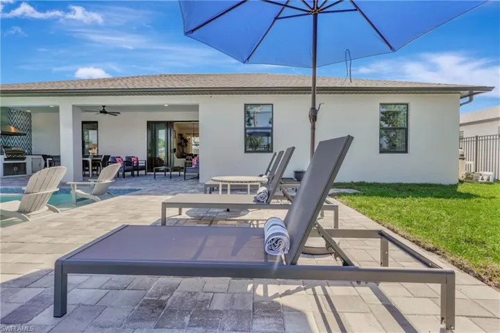 Back of property with a patio, stucco siding, and an outdoor kitchen