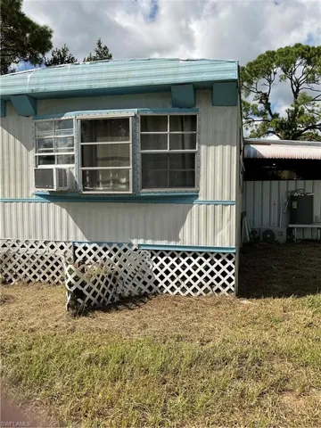 View of side of property with a yard