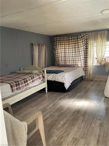 Bedroom featuring laminate flooring