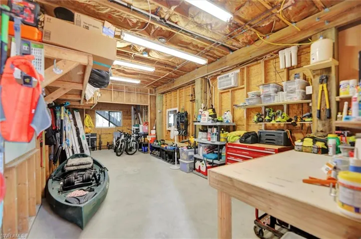 Basement featuring a workshop area and a wall mounted AC