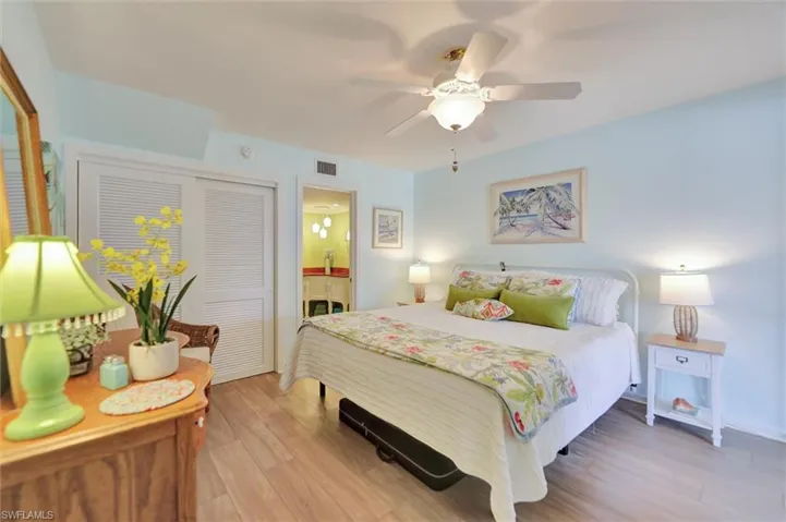 Bedroom featuring light wood-type flooring, a ceiling fan, and a closet