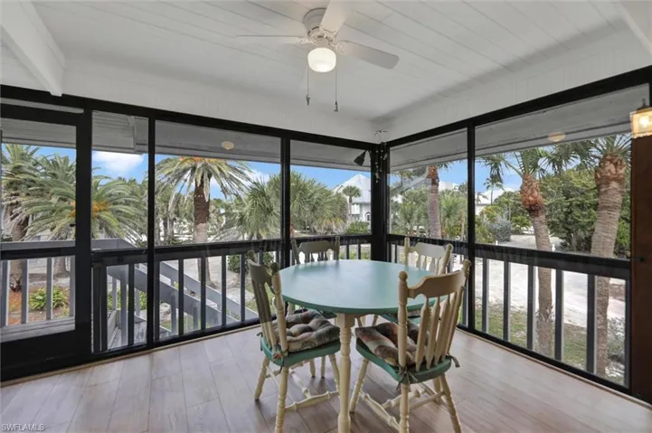 Sunroom with healthy amount of natural light and wood finished floors