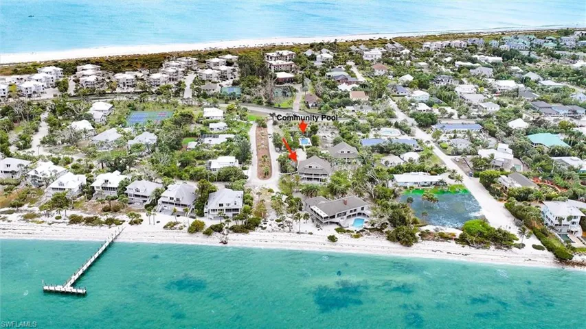 View of property location featuring expansive beach and nearby suburban area