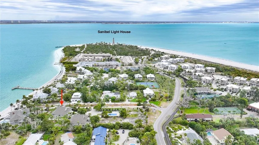 Aerial view of property and surrounding area with waterfront with a beach and nearby suburban area