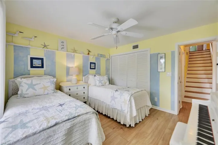 Bedroom featuring a closet, ceiling fan, and light wood-style flooring