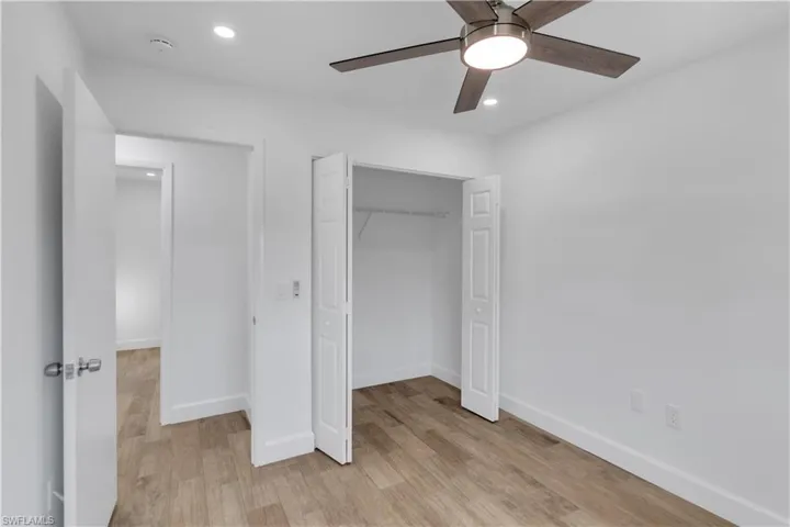 Unfurnished bedroom with a closet, recessed lighting, light wood-style flooring, and baseboards