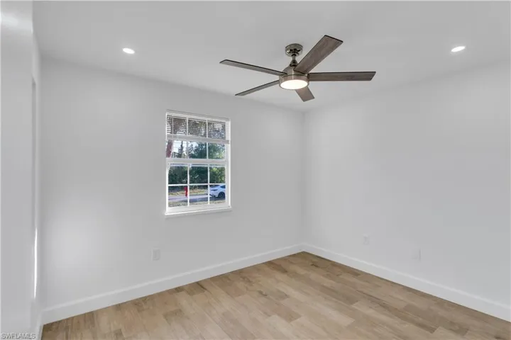 Spare room with recessed lighting, baseboards, light wood-type flooring, and a ceiling fan