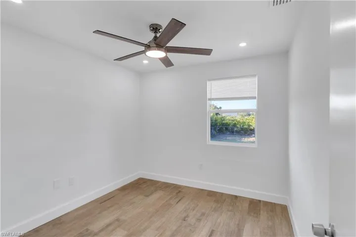 Unfurnished room featuring recessed lighting, ceiling fan, light wood-type flooring, and baseboards