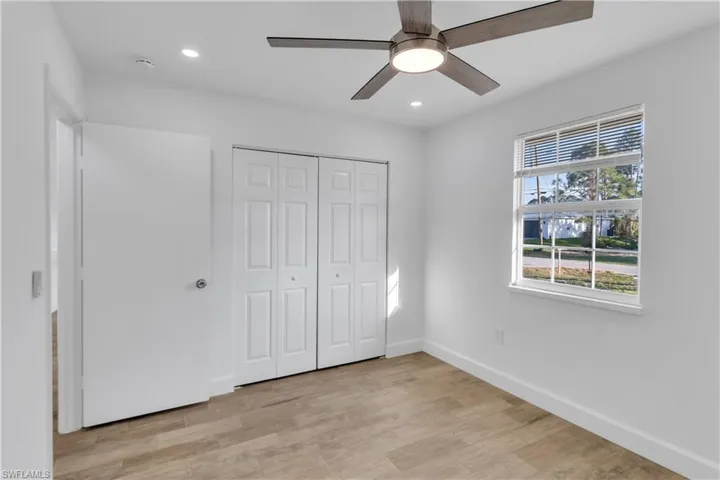 Unfurnished bedroom featuring baseboards, ceiling fan, light wood-type flooring, recessed lighting, and a closet