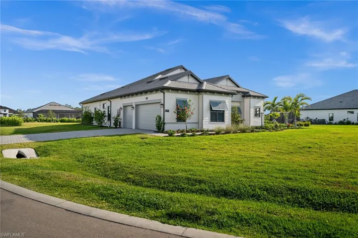Single story home with asphalt driveway, a garage, and a front lawn