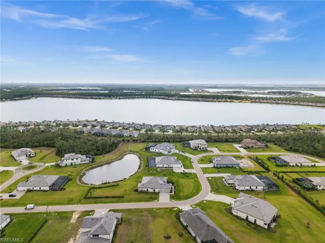 Aerial overview of property's location with a nearby body of water and nearby suburban area