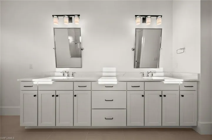 Bathroom with tile patterned floors and double vanity
