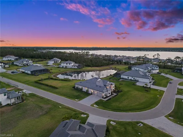 Aerial view at dusk of a water view and a residential view