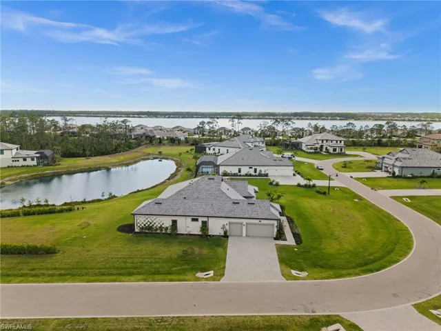 Aerial perspective of suburban area with a nearby body of water