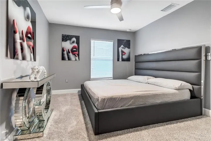Guest Bedroom 3 featuring light carpet and ceiling fan