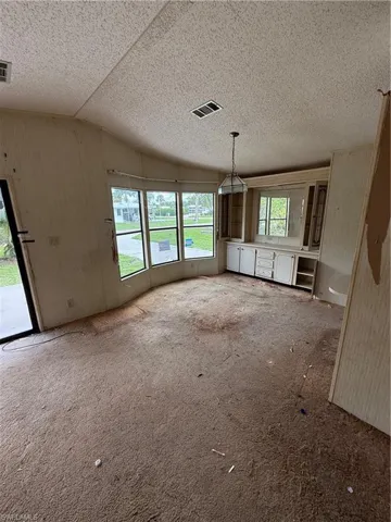 Unfurnished living room with vaulted ceiling