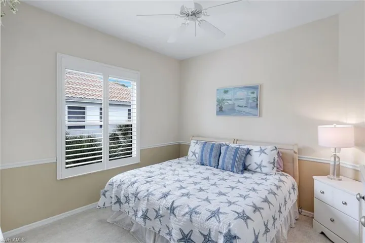 Bedroom with light colored carpet and ceiling fan