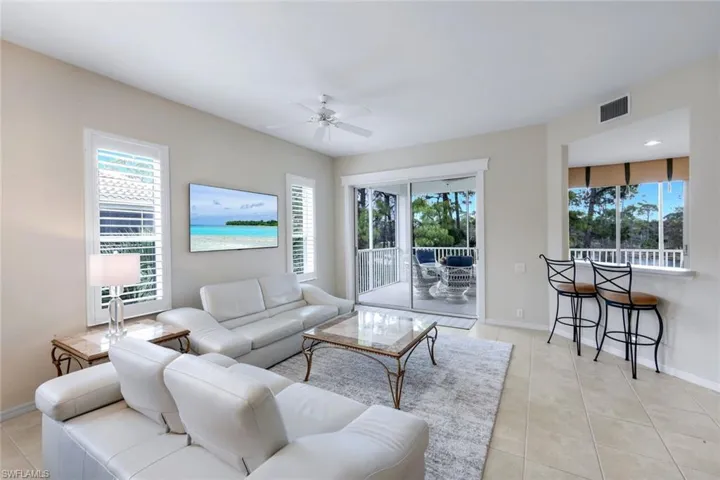 Living room featuring a ceiling fan and light tile patterned flooring