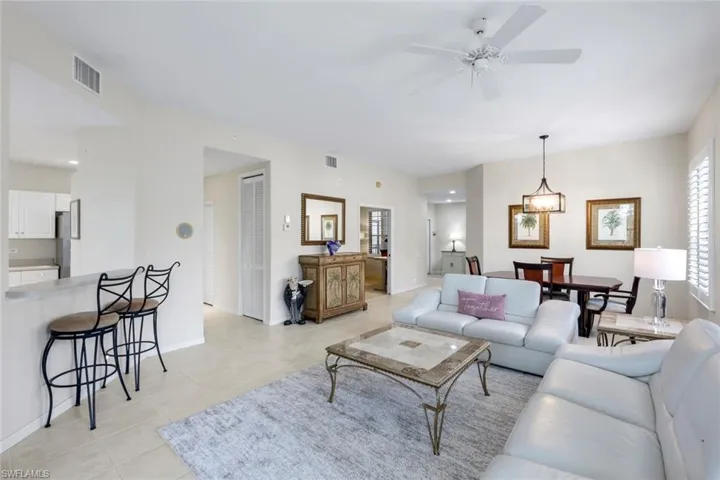 Living room featuring ceiling fan and light tile patterned floors