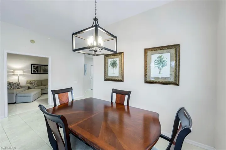 Dining space featuring hanging lights and light tile patterned floors