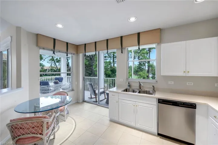 Kitchen with white cabinetry, dishwasher, light countertops, plenty of natural light, and recessed lighting