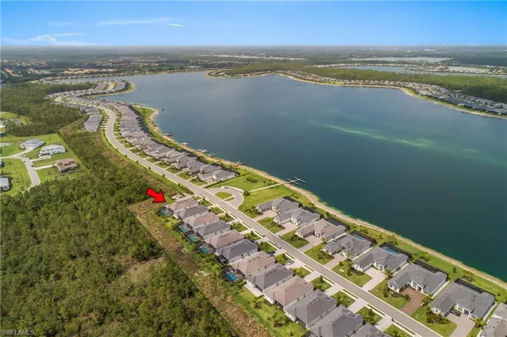 Aerial overview of property's location featuring a large body of water and nearby suburban area