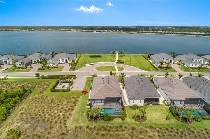 Aerial perspective of suburban area featuring a large body of water
