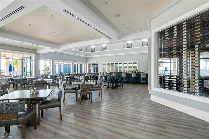 Dining space with wood finished floors, healthy amount of natural light, beam ceiling, and recessed lighting