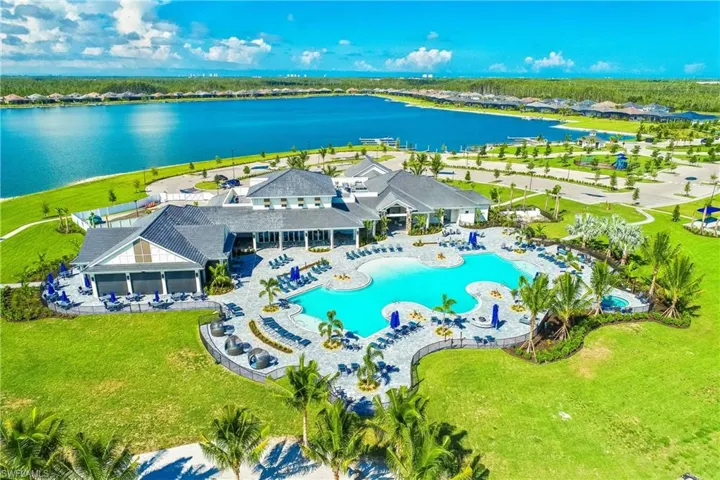 Aerial view of a pool area and a nearby body of water