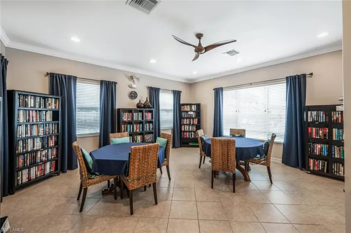 Club House Dining space with ceiling fan, light tile patterned flooring, and crown molding