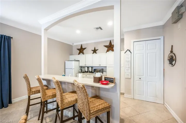 Club House Kitchen with tile floors, and white fridge