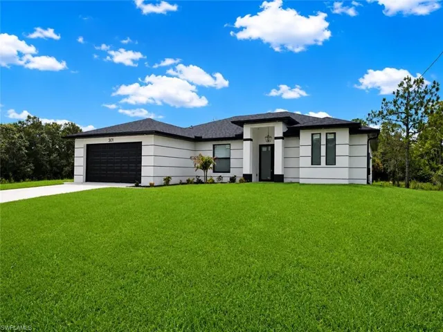 Contemporary exterior featuring a black roof, white facade with horizontal detailing, and a black garage door