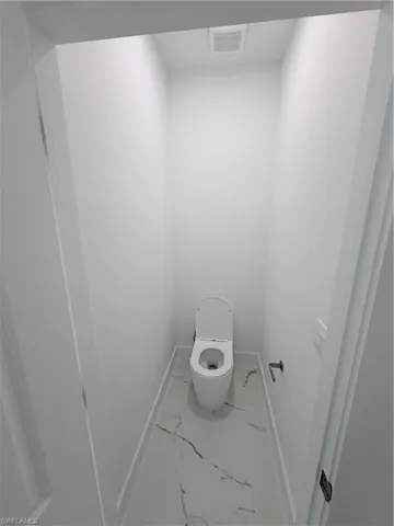 Bathroom with baseboards and marble finish flooring