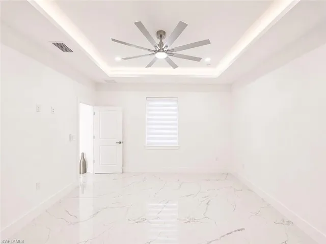 Recessed tray ceiling with integrated LED lighting and a multi-blade ceiling fan