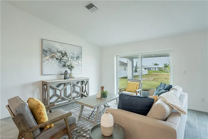 Living area featuring wood finish floors and vaulted ceiling