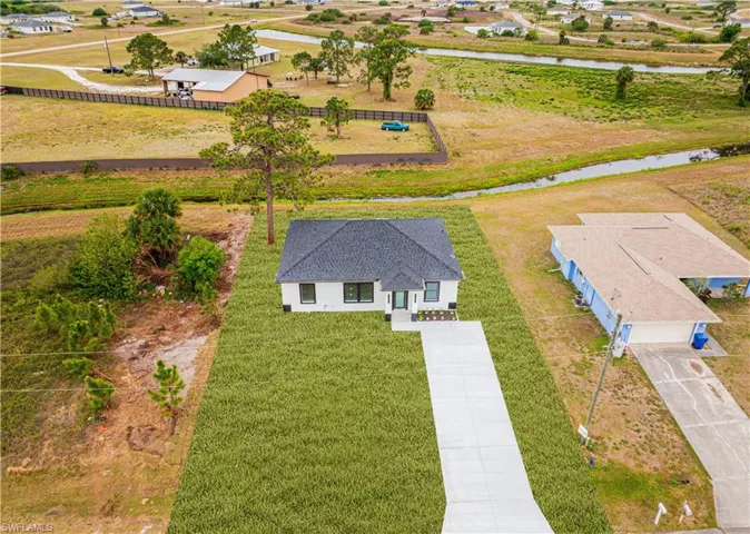 Birds eye view of property with a water view