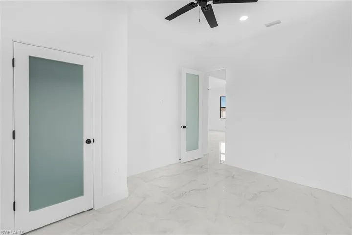 Unfurnished room featuring visible vents, baseboards, marble finish floor, ceiling fan, and recessed lighting