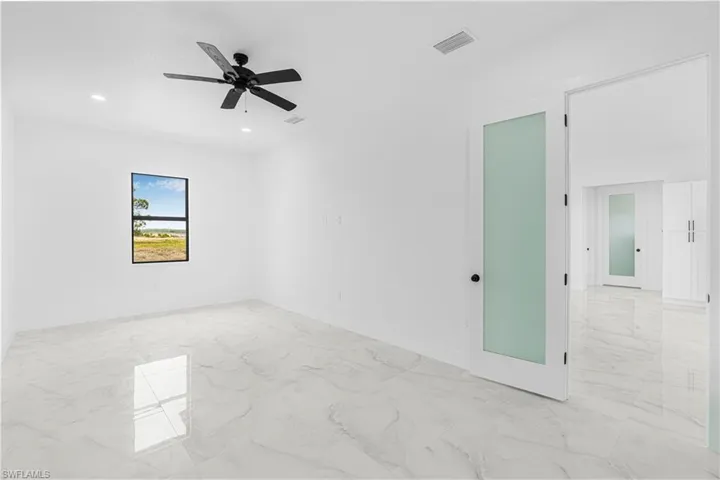 Unfurnished room featuring visible vents, baseboards, marble finish floor, recessed lighting, and a ceiling fan