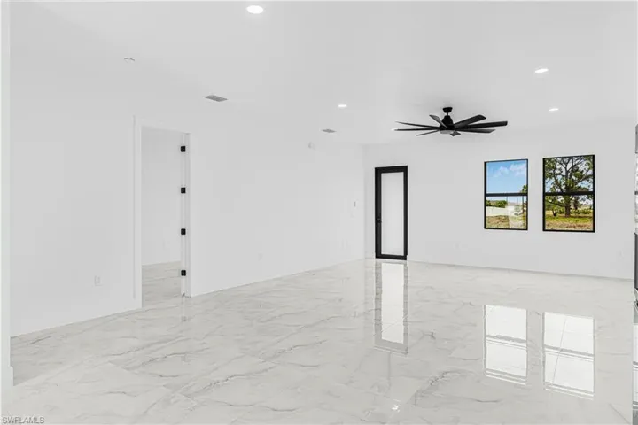 Empty room featuring marble finish floor, ceiling fan, visible vents, and recessed lighting