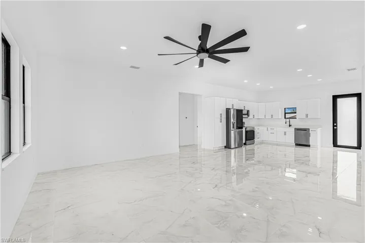 Unfurnished living room featuring marble finish floor, visible vents, recessed lighting, and a ceiling fan