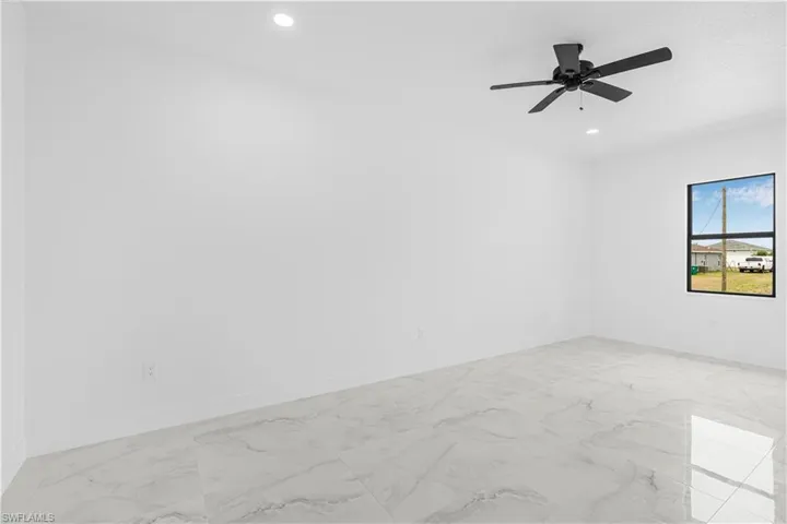 Spare room with marble finish floor, baseboards, ceiling fan, and recessed lighting