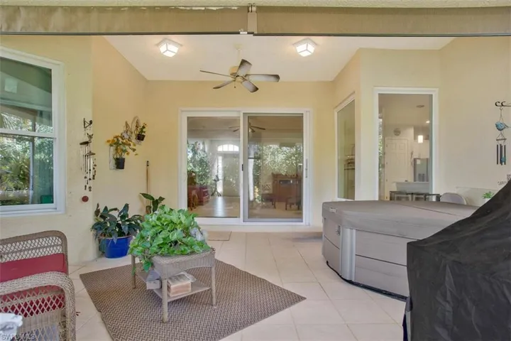 Living room with light tile patterned flooring and ceiling fan