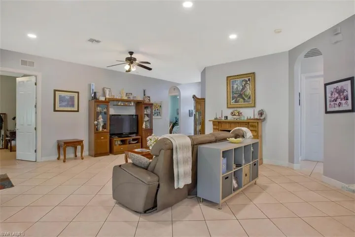 Tiled living room featuring ceiling fan
