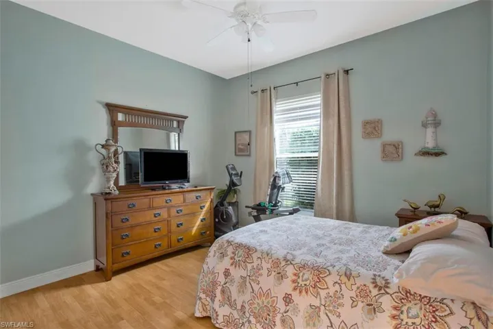 Bedroom with light hardwood / wood-style flooring and ceiling fan