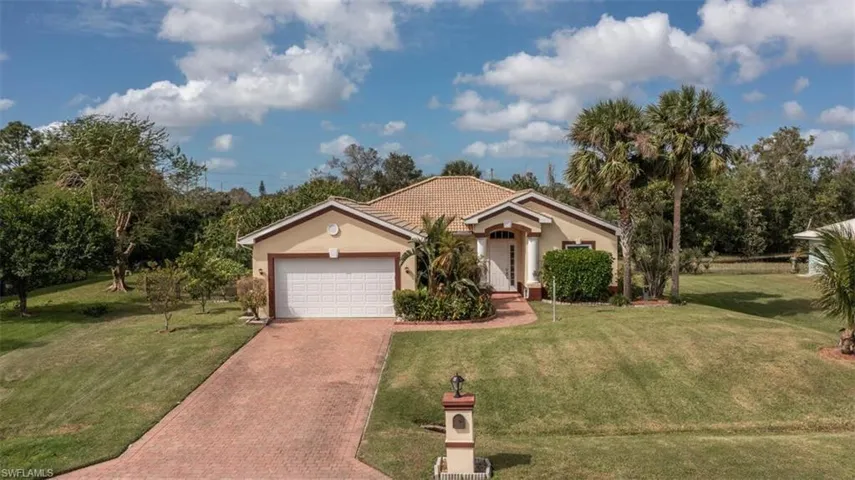 View of front of property with a front lawn and a garage